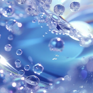Macro of clear water droplets across a soft blue surface, evoking the purifying mist of hypochlorous acid.