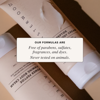 Two crossed Power Peptide Body Cream tubes with cream squeeze, callout that Asterwood formulas are paraben, sulfate, fragrance, dye free and cruelty-free.