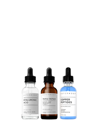 Asterwood Bounce Back Trio: Hyaluronic Acid serum, Triple Repair amber serum, and Copper Peptides blue serum lined up on white.