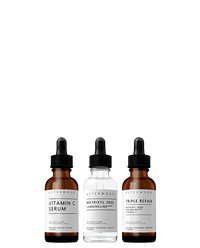 Asterwood Powerhouse Trio on white: the amber Vitamin C Serum, the clear Matrixyl 3000 + Argireline Serum, and the amber Triple Repair Serum in dropper bottles.
