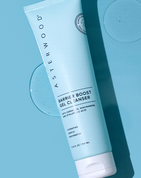 Top-down shot of Asterwood Barrier Boost Gel Cleanser tube on blue background with two clear gel circles, showing the ceramide formula.