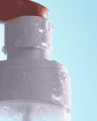 Animated close-up of Asterwood Hypochlorous Acid Facial Mist droplets beading on the frosted bottle against a soft blue background.
