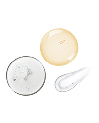 Macro swatches representing the Skincare Essentials Set: clear HA gel, golden Triple Repair drop, and a white moisturizer streak.