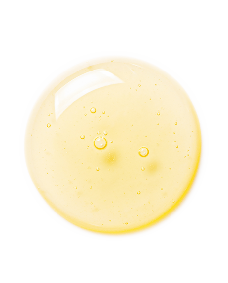 Top-down macro of a golden-yellow Vitamin C Serum droplet on white showing the bright vitamin C texture.